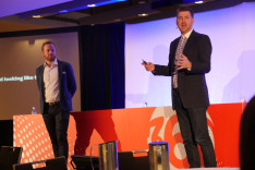 Jim Ingram and Chris Jeffares presenting onstage at Mumbrella360