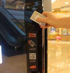 Shoppers can donate to charities by tapping on an outdoor sign