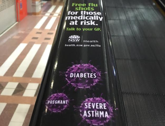 State government flu campaign ads rolled out on escalator handrails