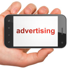 Marketing concept: hand holding smartphone with word Advertising on display. Mobile smart phone on White background, 3d render