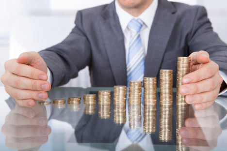 thinkstockphotos-man-coins-stack-money
