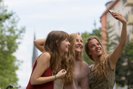 Three beautiful and young girls taking selfie