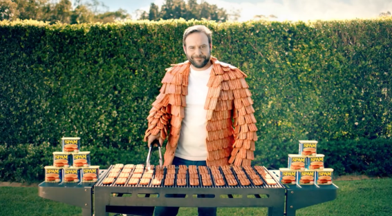 Man wearing SPAM jacket sells the sizzle of putting some on the barbie